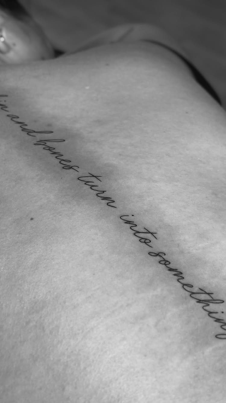 Back Ribs Tattoo Ideas: 7 Designs, Vines to Octopus 2 Cursive script tattoo on a person's ribs with a meaningful written phrase.