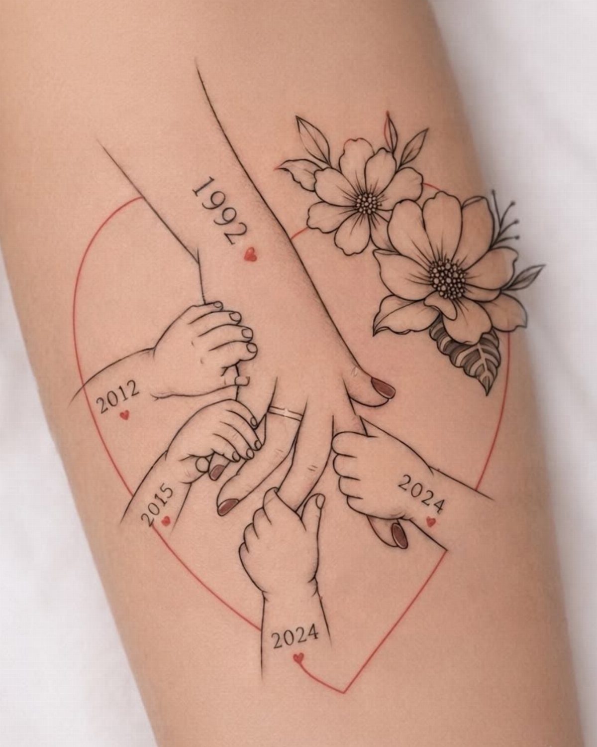 Tattoo of an adult hand held by children's hands with birth years and flowers.