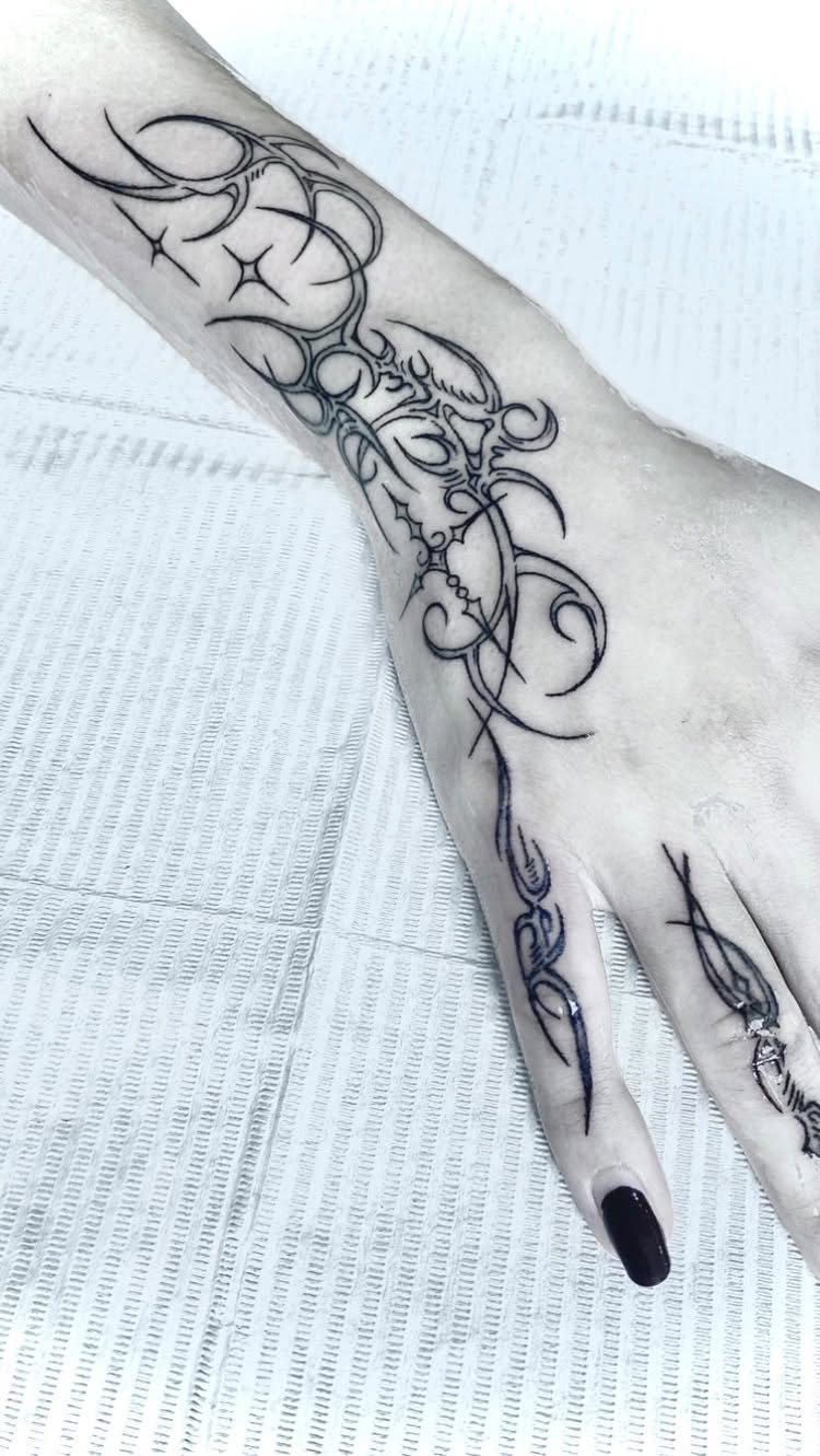 Cybersigilism tattoo on a hand and wrist with flowing black organic curves.