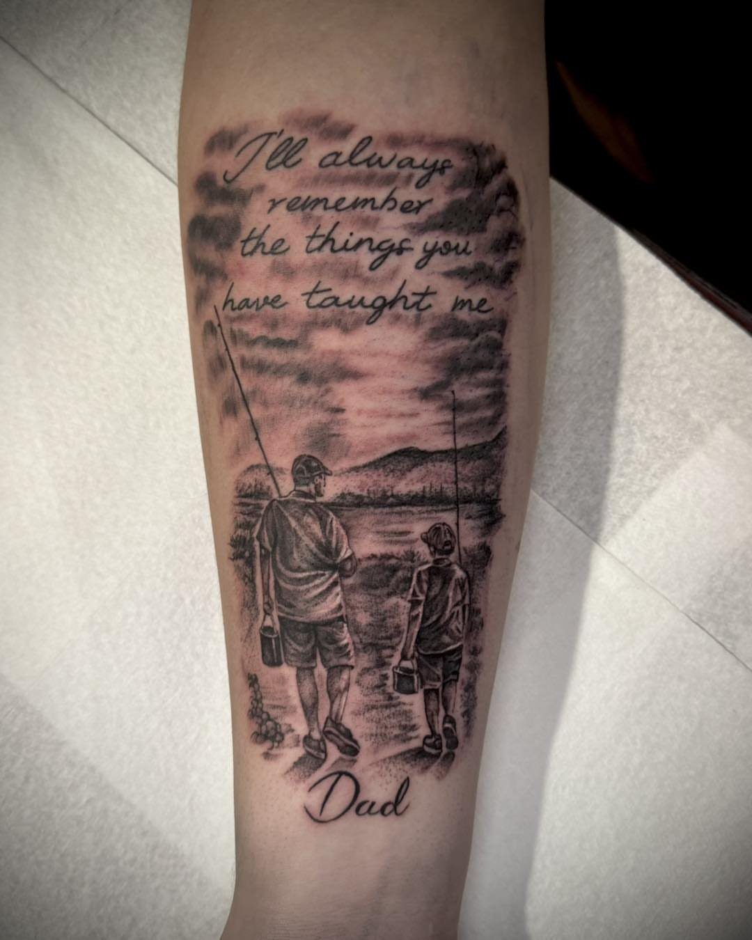 Tattoo of a father and daughter fishing with a sentimental quote and Dad.