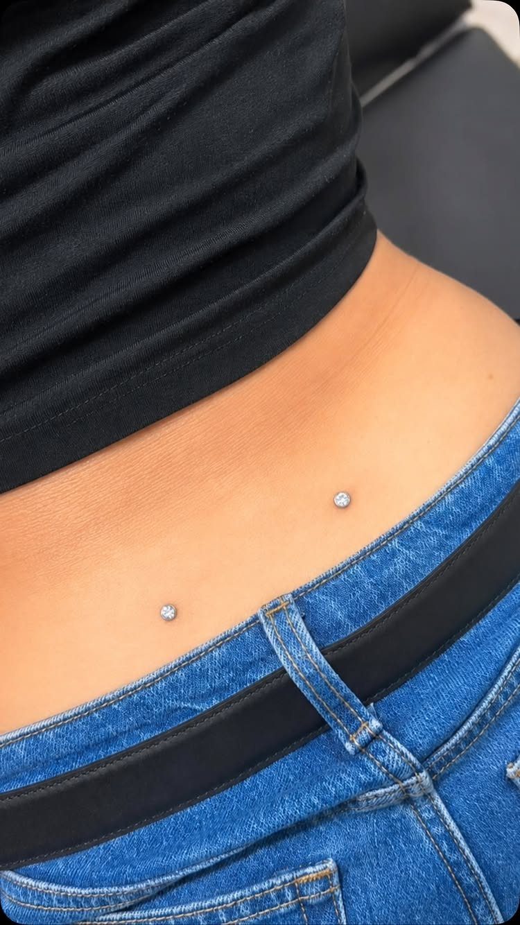 Dermal Piercing for Back Dimples: 7 Ideas and Jewelry 7 Two sparkling dermal piercings in the dimples of a person's lower back
