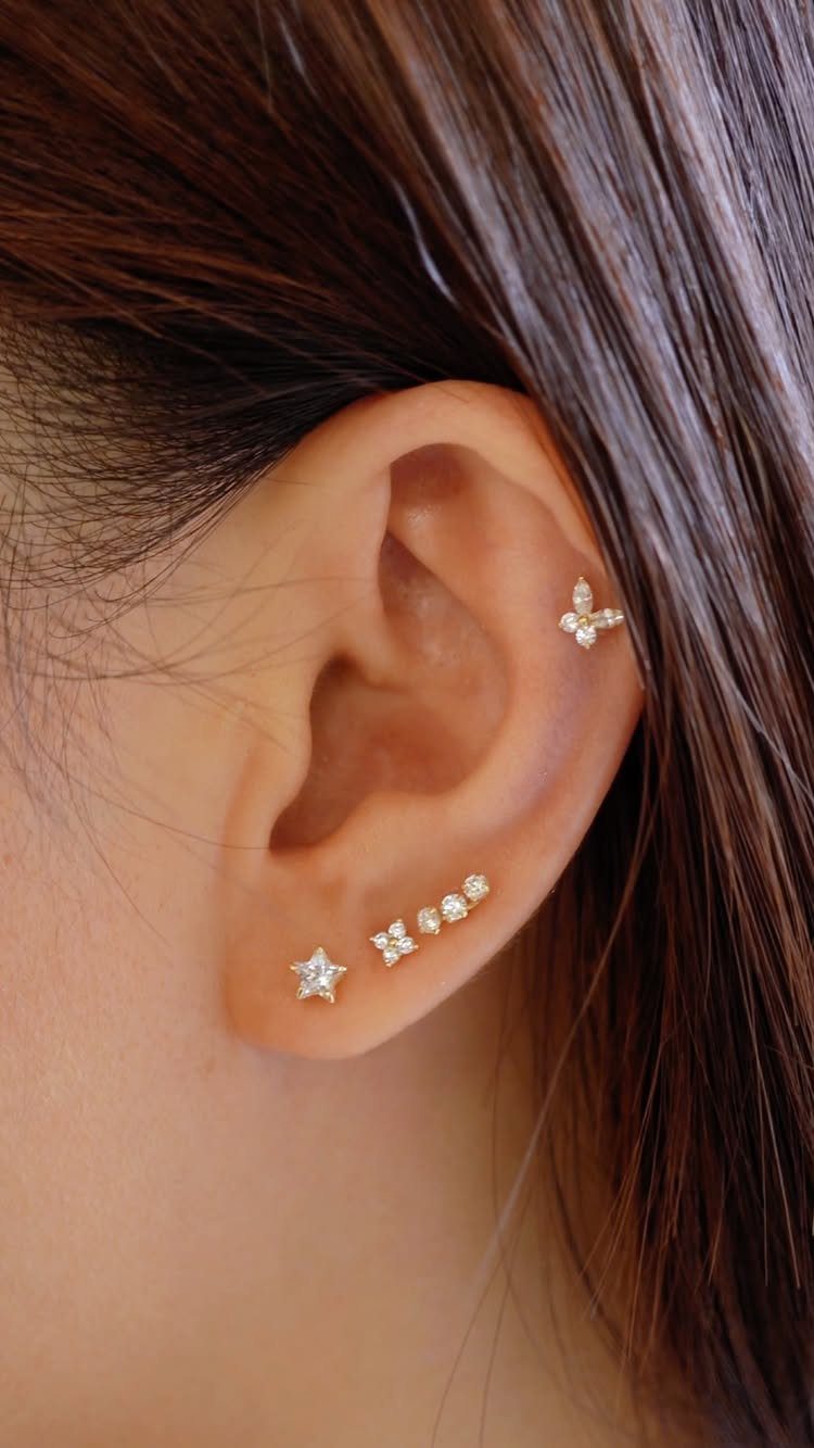 12 Ear Piercing Combo Ideas for Every Style 4 Ear with a linear stack of gold studs and a helix flower piercing