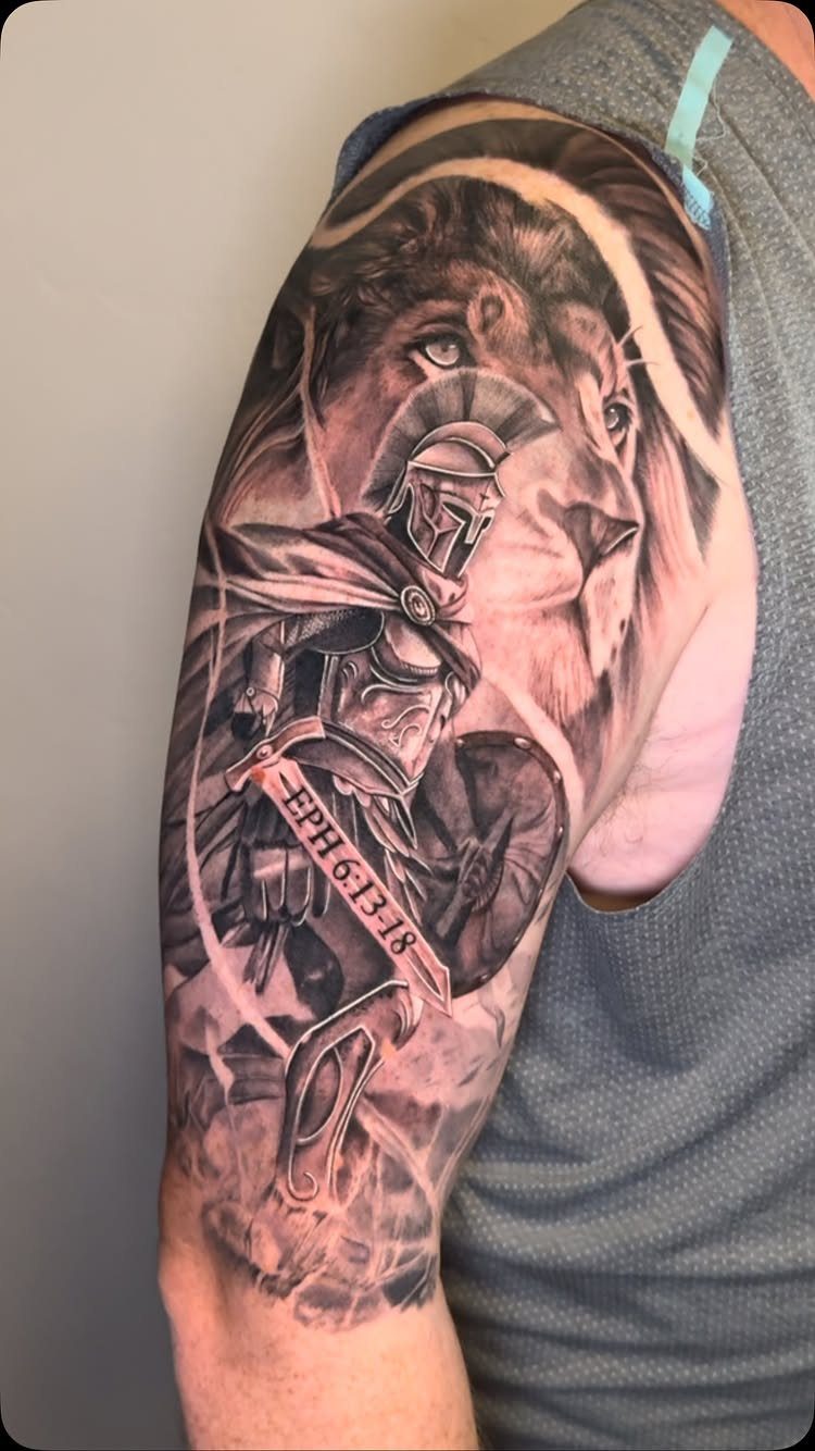 Sleeve tattoo of a Roman soldier in armor and a lion with scripture reference.