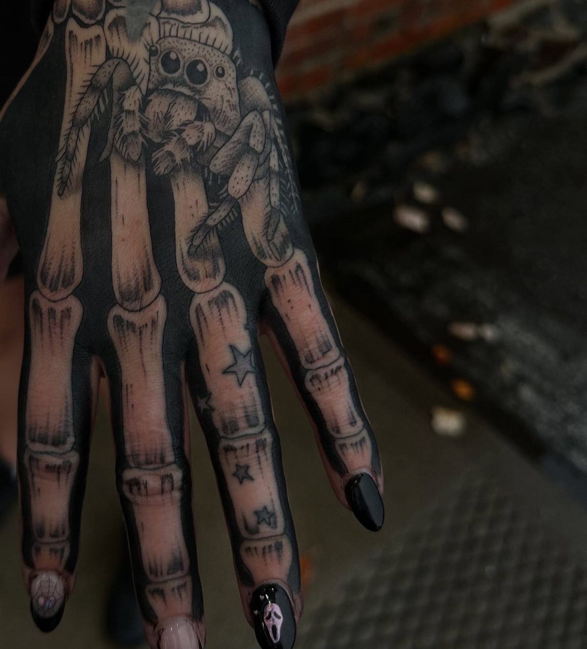 15 Hand Pen Tattoo Ideas for Spider Webs, Flowers and More 5 Hand with a detailed anatomical bone tattoo and a small character on top.