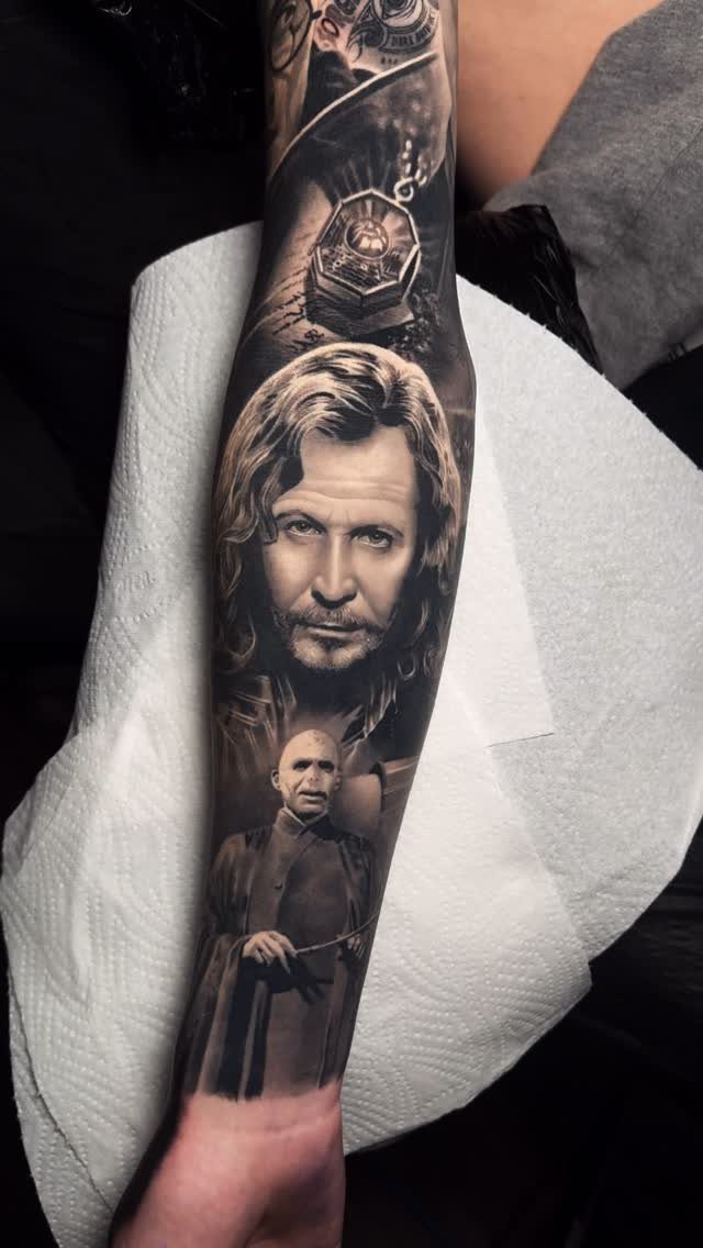 Realistic black and grey tattoo of Sirius Black and Lord Voldemort on a forearm