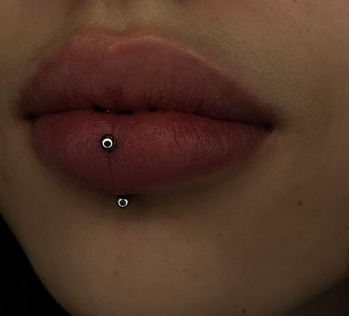 Lip Piercings for Small Lips: 7 Styles to Consider 7 Lips with a lowbret piercing and a standard labret piercing in silver studs.