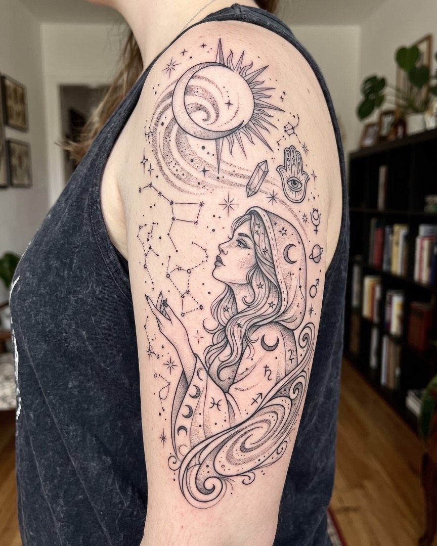 Detailed black ink tattoo of a mystical woman with celestial symbols on an arm.