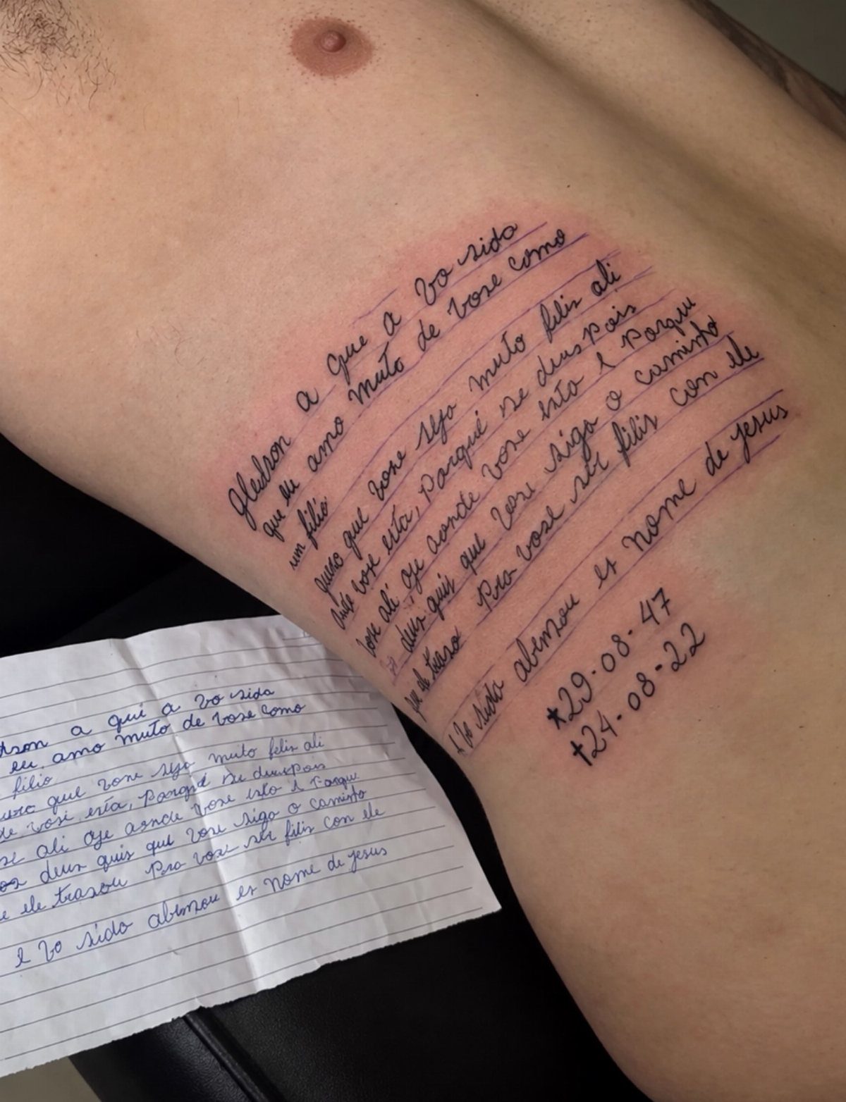 Handwritten letter tattoo on a person's ribs with original note for comparison.