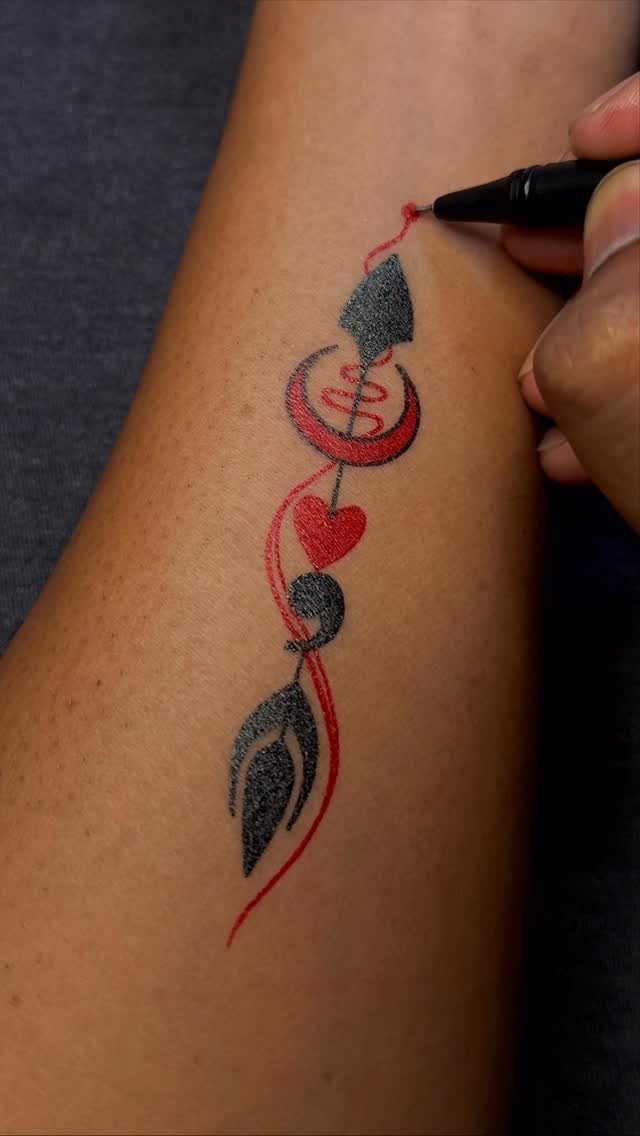 26 Self Tattoo Ideas for Simple, Meaningful Ink 11 Arrow and heart tattoo design being drawn on a person's arm with markers.