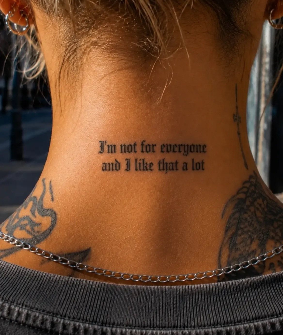 26 Self Tattoo Ideas for Simple, Meaningful Ink 13 Black ink lettering tattoo on the back of a neck with gothic text.
