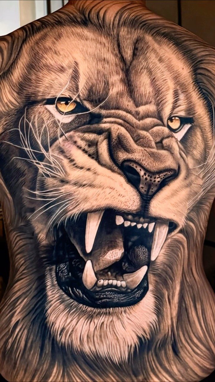 26 Self Tattoo Ideas for Simple, Meaningful Ink 4 Detailed roaring lion tattoo covering the entire back of a person.