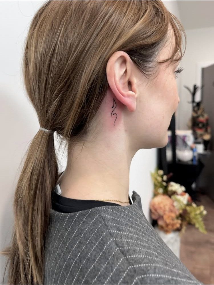 26 Self Tattoo Ideas for Simple, Meaningful Ink 7 Small black music note tattoo located behind a woman's right ear.