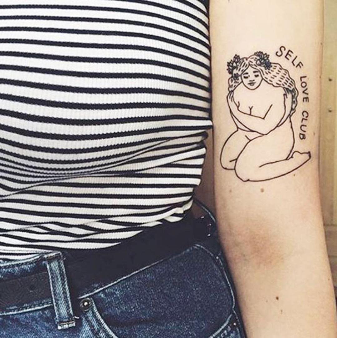 26 Self Tattoo Ideas for Simple, Meaningful Ink 14 Tattoo of a woman hugging herself with the text SELF LOVE CLUB on arm