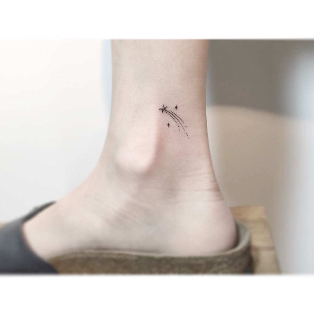 26 Self Tattoo Ideas for Simple, Meaningful Ink 6 Small shooting star tattoo with a dotted trail on a person's ankle.