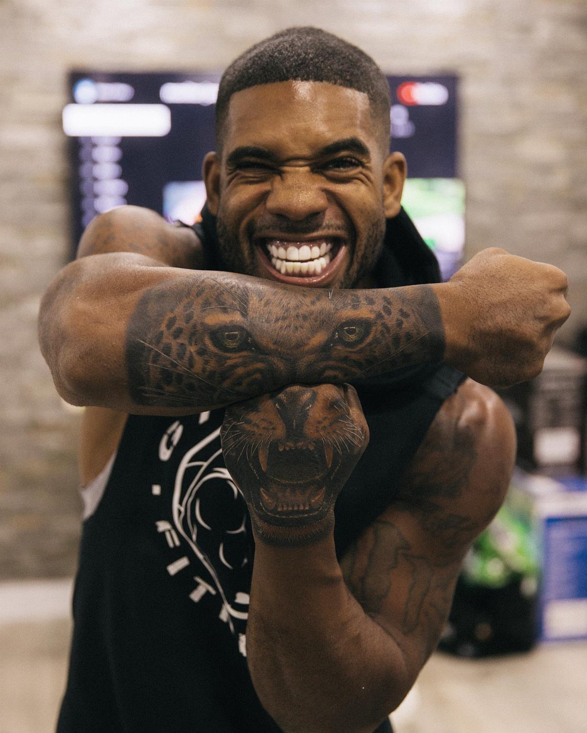 9 Side Arm Tattoos for Animals, Script, Florals and More 2 Man with a realistic leopard tattoo wrapping around both of his muscular forearms.