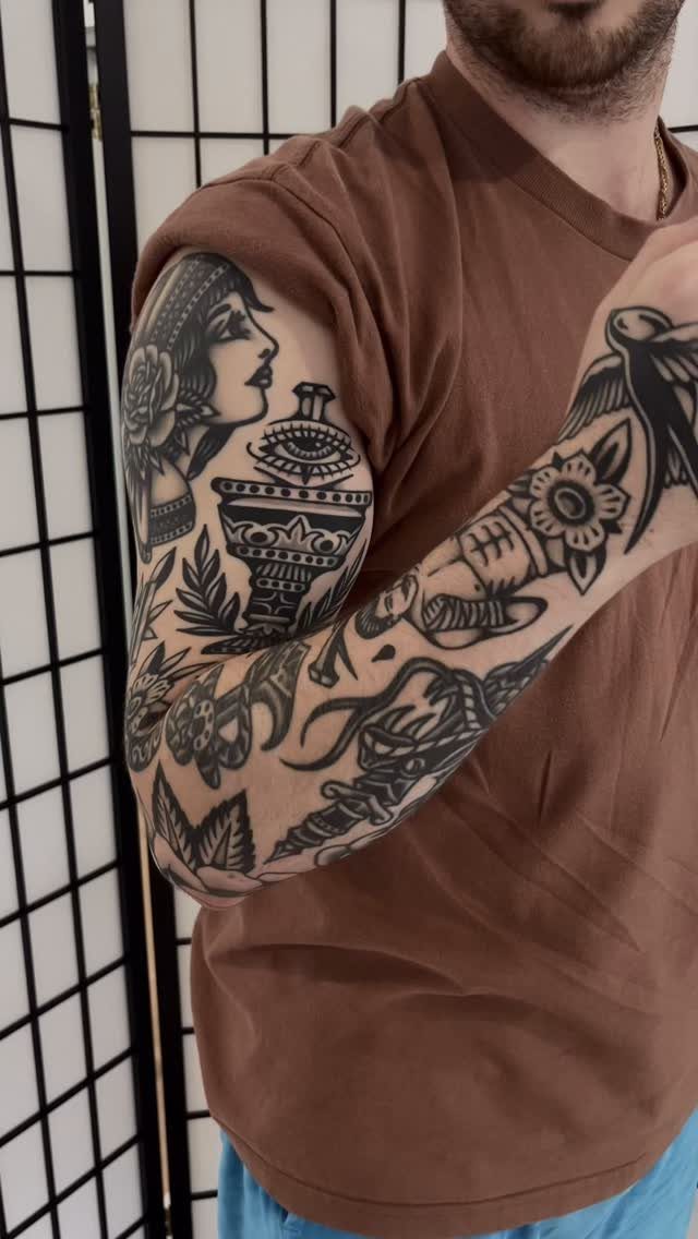9 Side Arm Tattoos for Animals, Script, Florals and More 5 Half sleeve tattoo on a man's arm with traditional black ink designs.