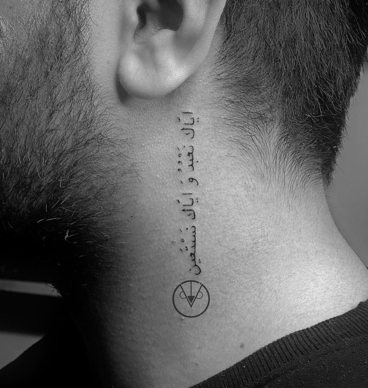 21 Side Neck Tattoo Ideas for Bold, Meaningful Designs 13 Arabic calligraphy tattoo on the side of a man's neck with a circular symbol.