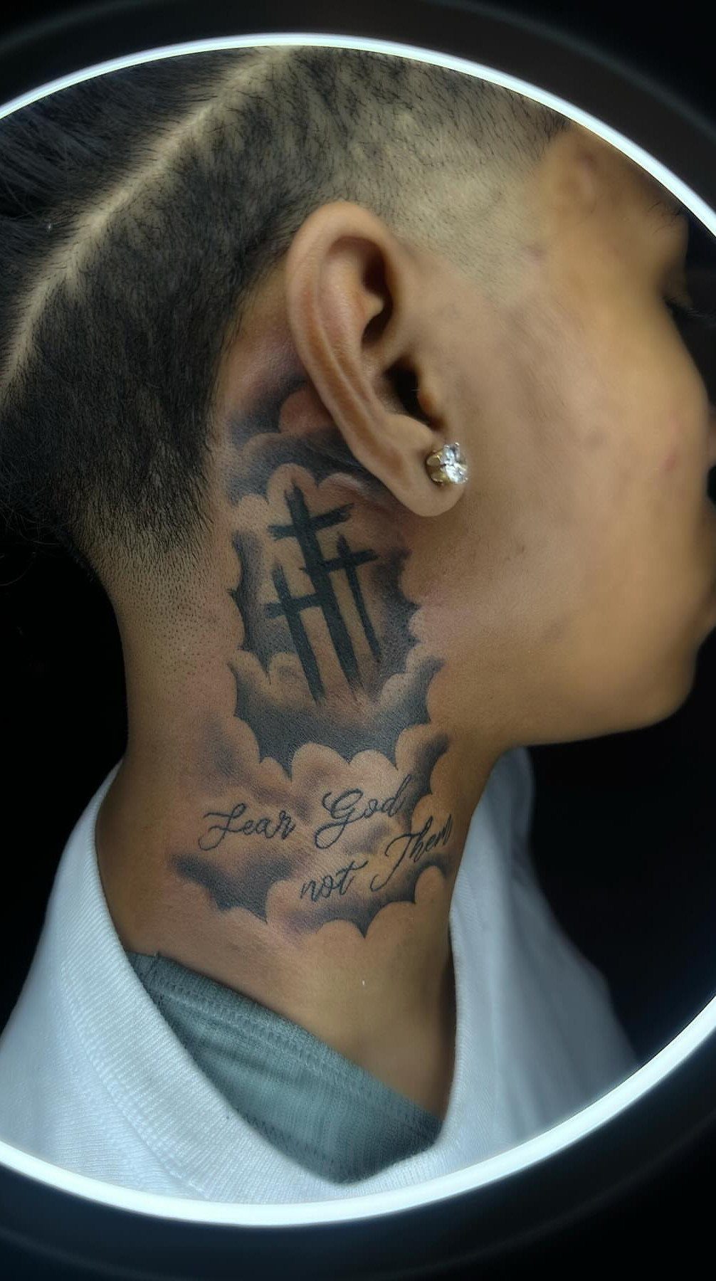 21 Side Neck Tattoo Ideas for Bold, Meaningful Designs 11 Cross neck tattoo with clouds and cursive text on a person's side neck.