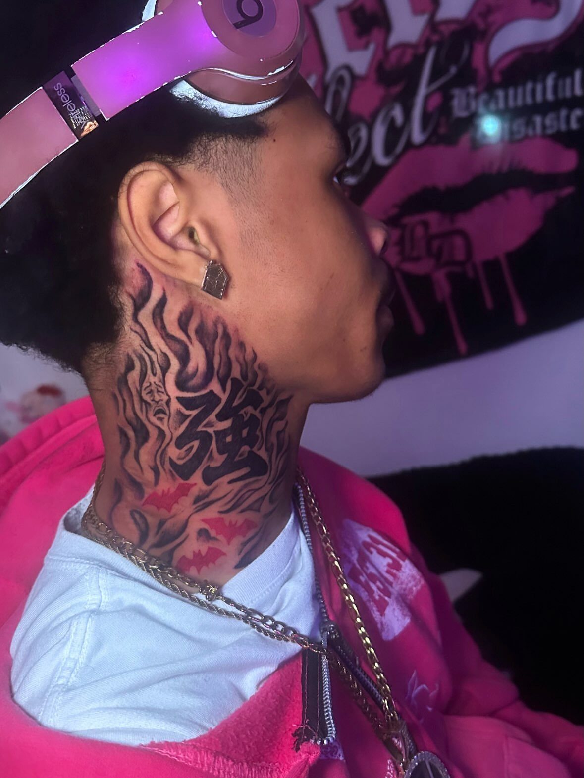 21 Side Neck Tattoo Ideas for Bold, Meaningful Designs 12 Person with a large black ink tattoo on the side of their neck.