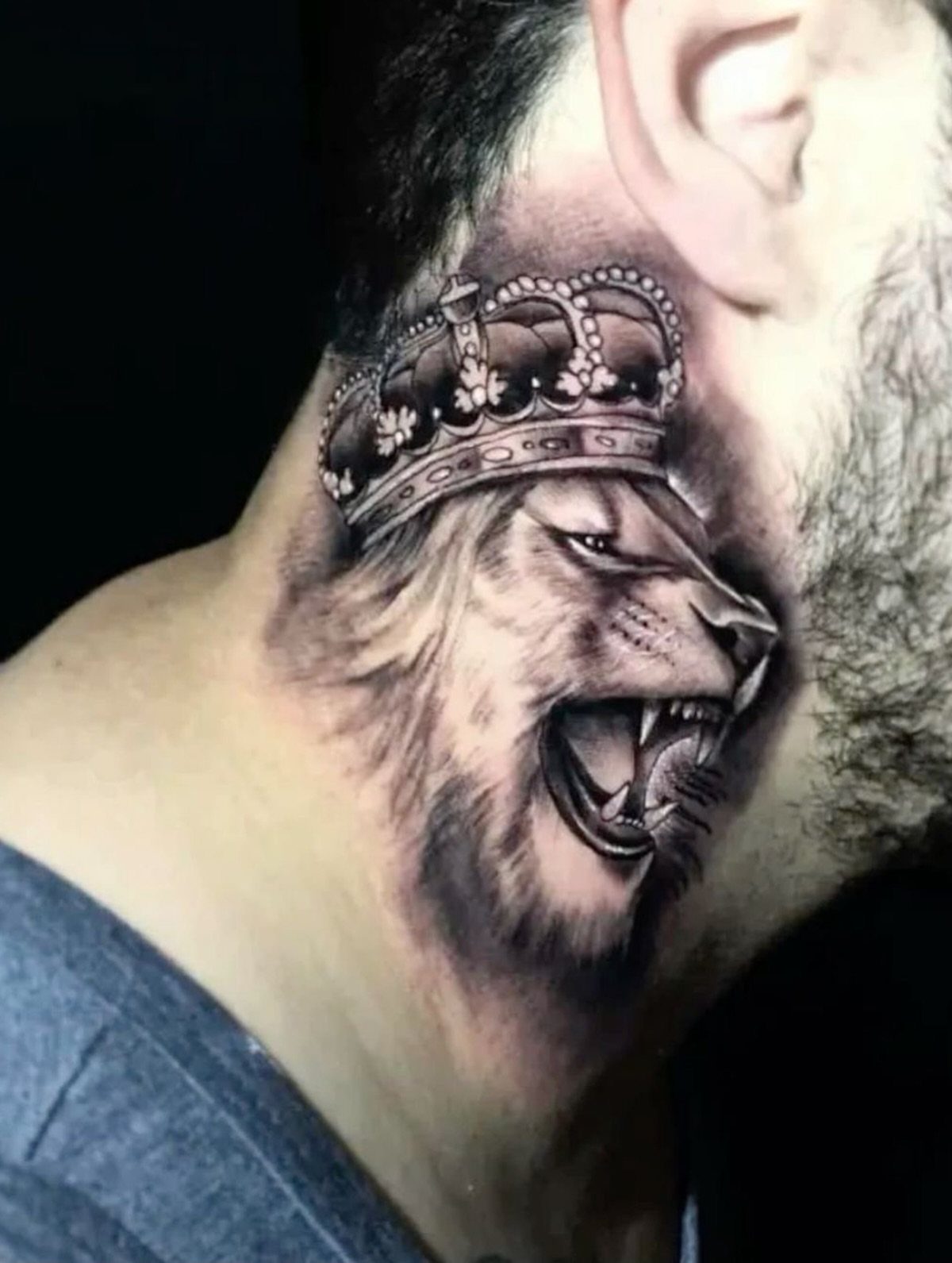 21 Side Neck Tattoo Ideas for Bold, Meaningful Designs 16 Roaring lion wearing a crown tattooed on the side of a man's neck.
