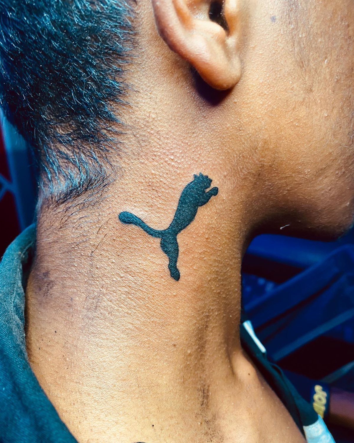 21 Side Neck Tattoo Ideas for Bold, Meaningful Designs 21 Small black silhouette tattoo of a leaping panther on a person's side neck.