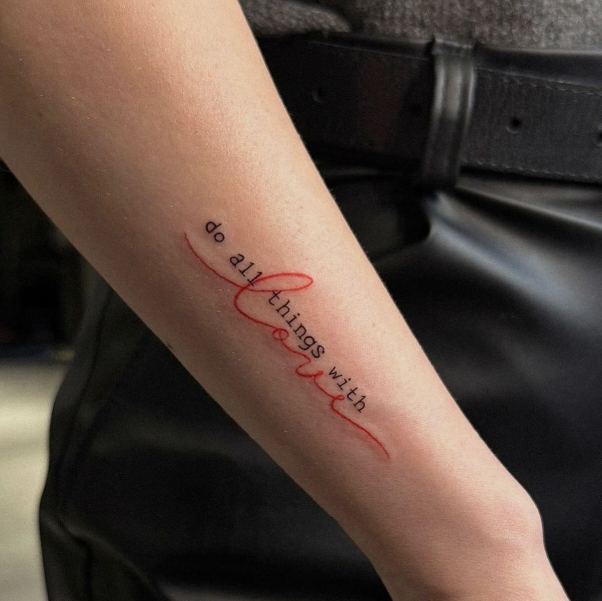 26 Small Pretty Tattoos for Butterflies, Stars, and More 17 Forearm tattoo with the quote do all things with love in black and red