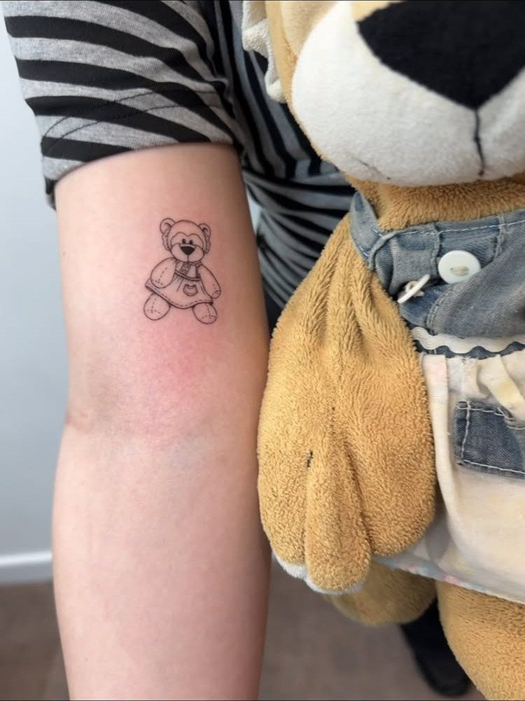 26 Small Pretty Tattoos for Butterflies, Stars, and More 12 Small teddy bear tattoo on an arm next to a real plush bear.