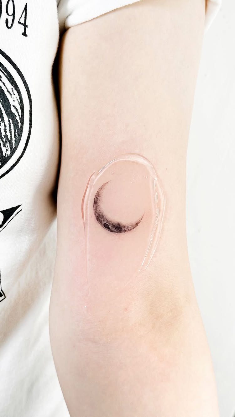 26 Small Pretty Tattoos for Butterflies, Stars, and More 14 Small black crescent moon tattoo on a person's inner forearm with protective film.