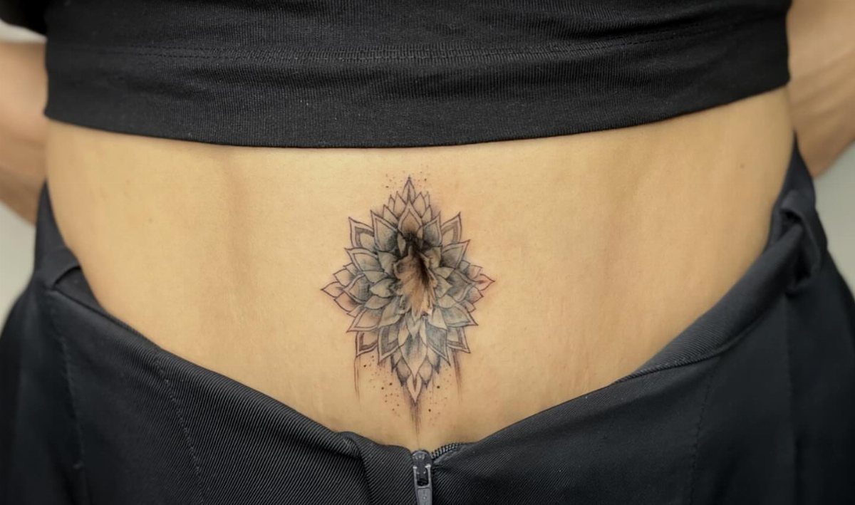 Tattoos Around Belly Button: 8 Best Ideas to Consider 6 Mandala tattoo with geometric petals centered around a person's belly button.